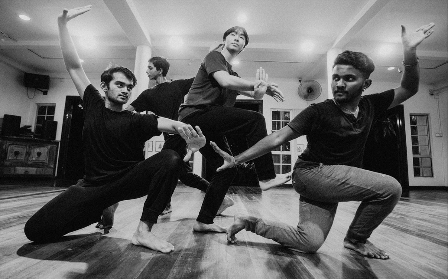 Dancers in a black and white studio rehearsal photograph